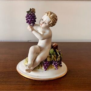 Antique Porcelain Capodimonte Putti or Cherub Figure Holding Grapes